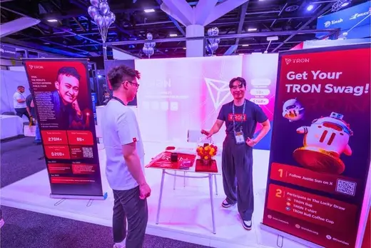 Visitors at the TRON booth collecting merchandise.